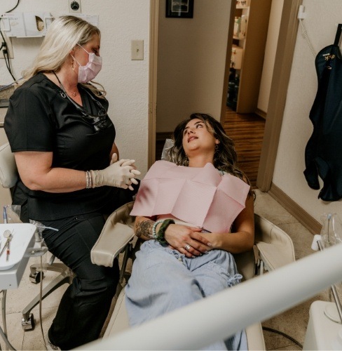 dental team member speaking with patient